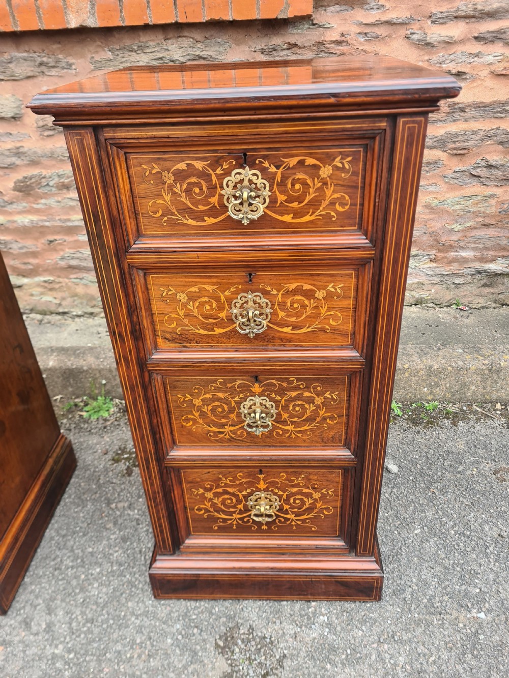 A pair of Victorian rosewood bedside cabinets featuring intricate floral marquetry inlays, four drawers each, and brass handles. View III