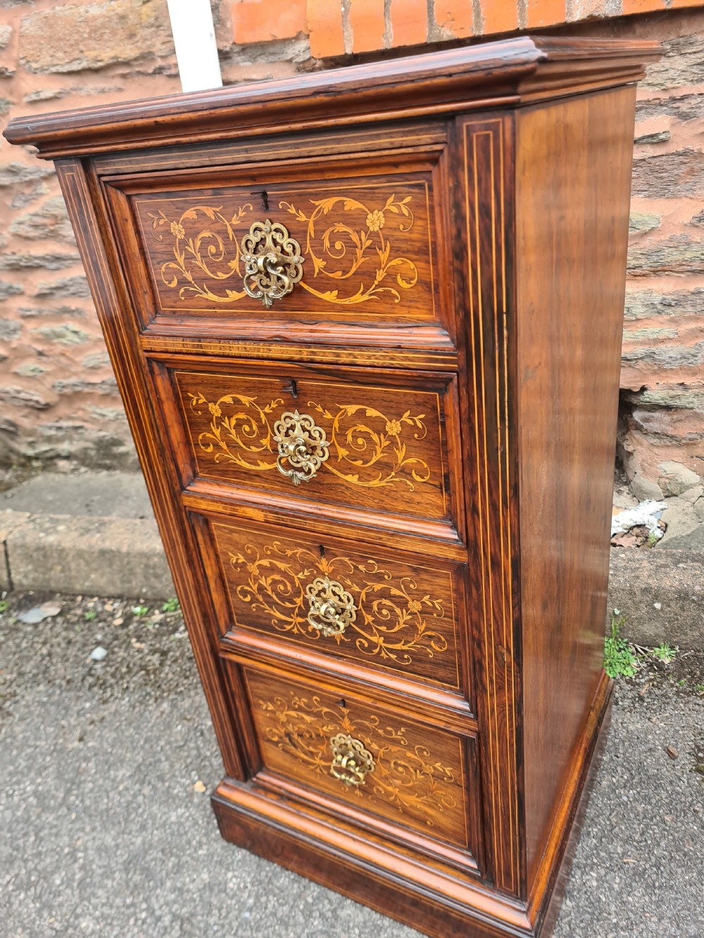A pair of Victorian rosewood bedside cabinets featuring intricate floral marquetry inlays, four drawers each, and brass handles. View IV