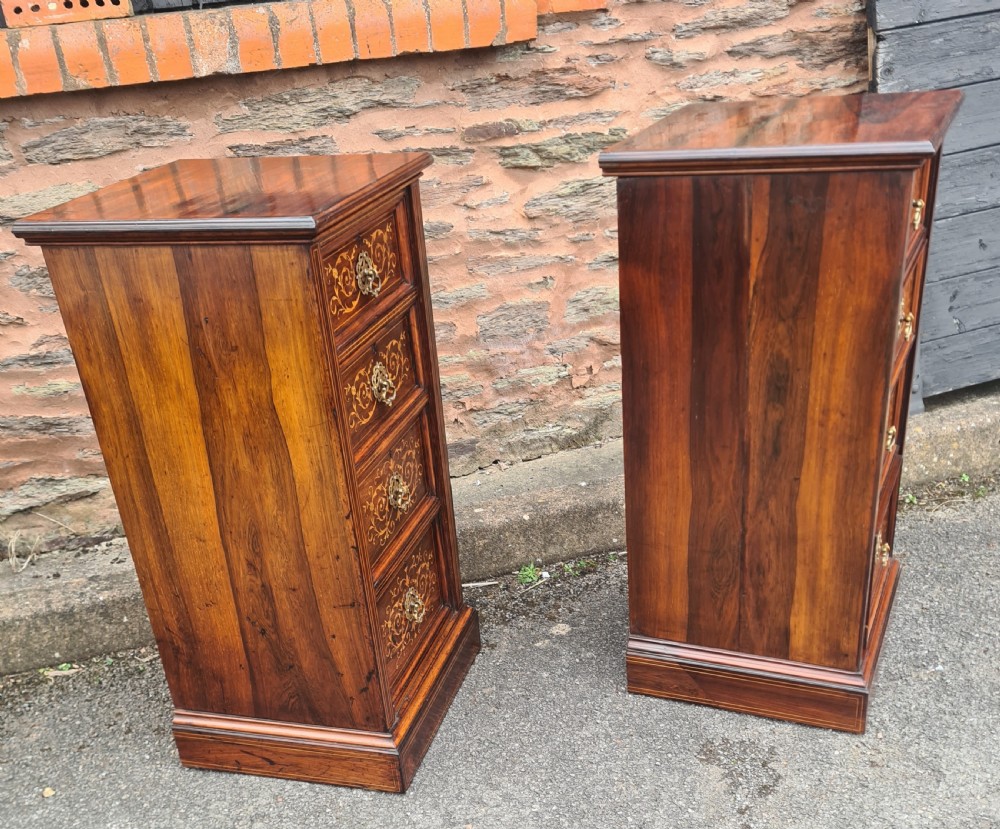 A pair of Victorian rosewood bedside cabinets featuring intricate floral marquetry inlays, four drawers each, and brass handles. View VIII