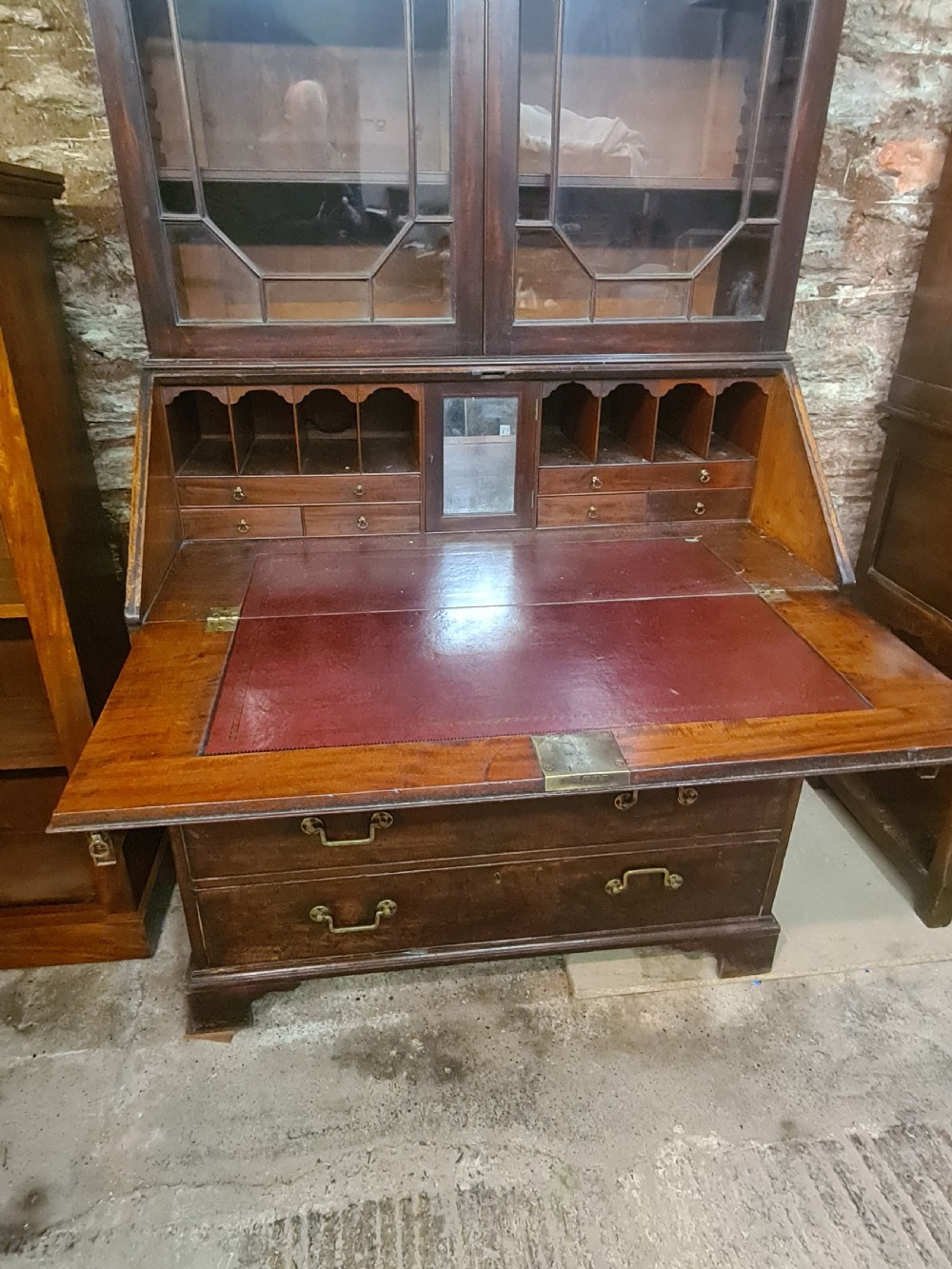 An 18th-century Georgian mahogany bureau bookcase featuring an upper astragal glazed cabinet with a pediment top above a slant-front desk and four drawers. View III