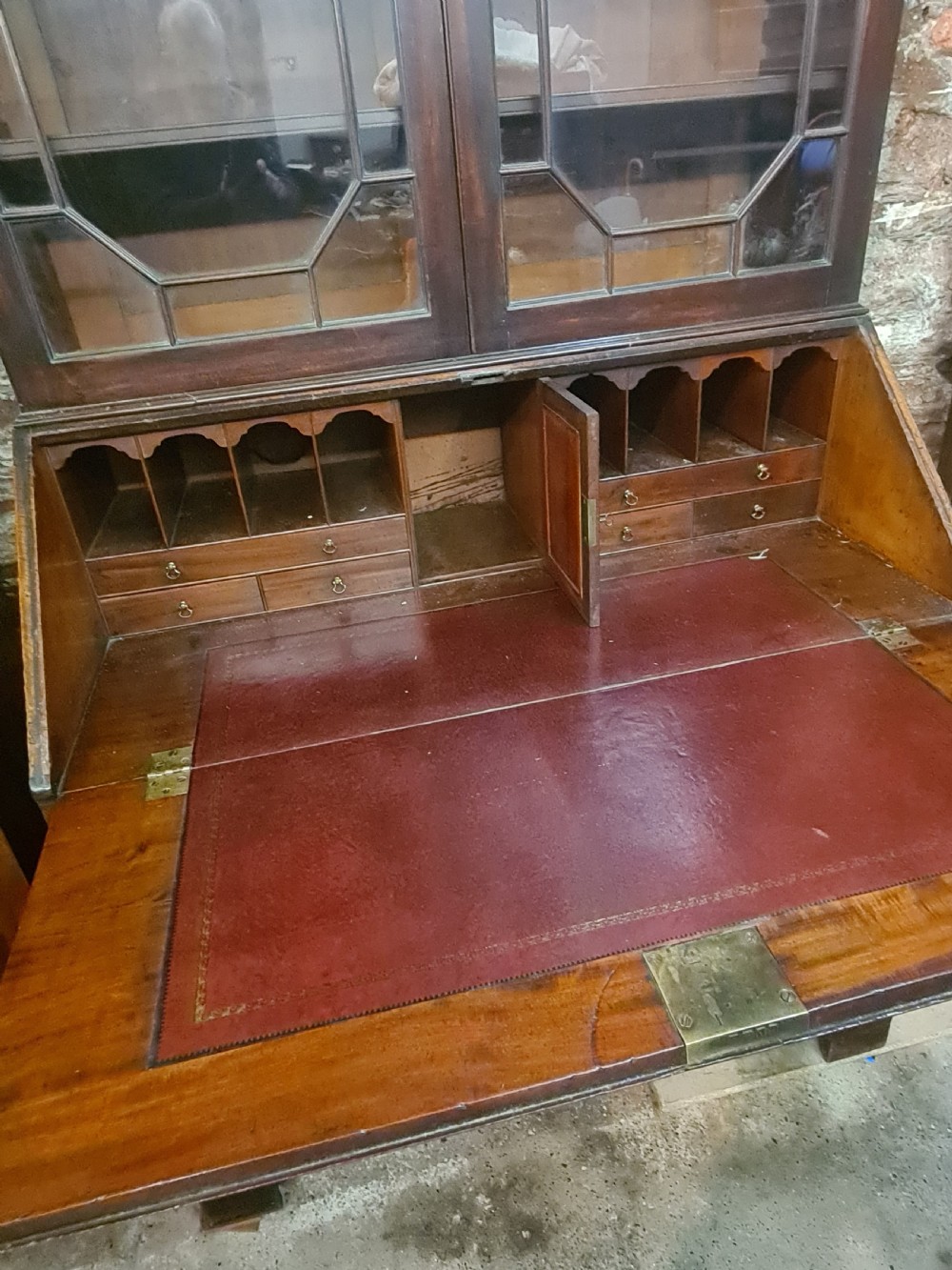 An 18th-century Georgian mahogany bureau bookcase featuring an upper astragal glazed cabinet with a pediment top above a slant-front desk and four drawers. View VII