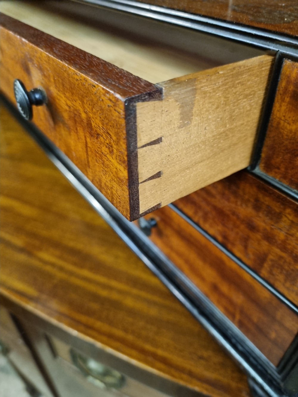 A nineteenth-century mahogany tabletop stationery cabinet featuring an open upper compartment with pigeonholes and turned side columns above six small drawers with dark turned knobs. View VIII