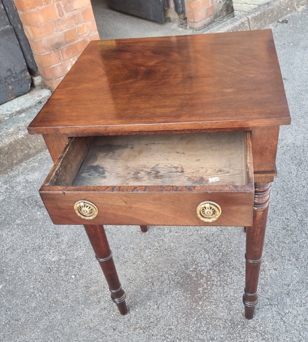 A 19th-century mahogany side table featuring a single drawer with two circular brass ring pulls and four tall turned legs. View II