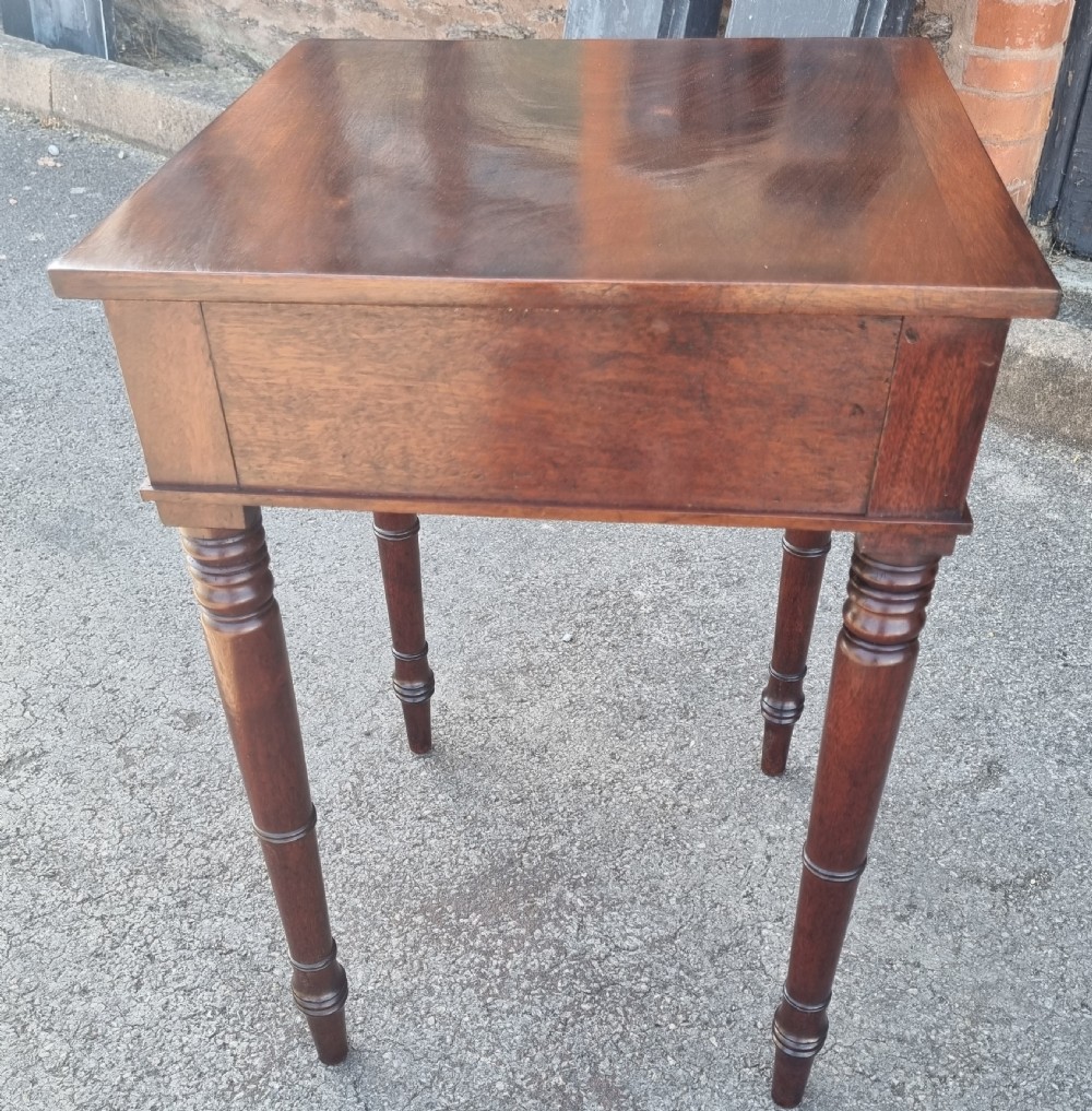 A 19th-century mahogany side table featuring a single drawer with two circular brass ring pulls and four tall turned legs. View III