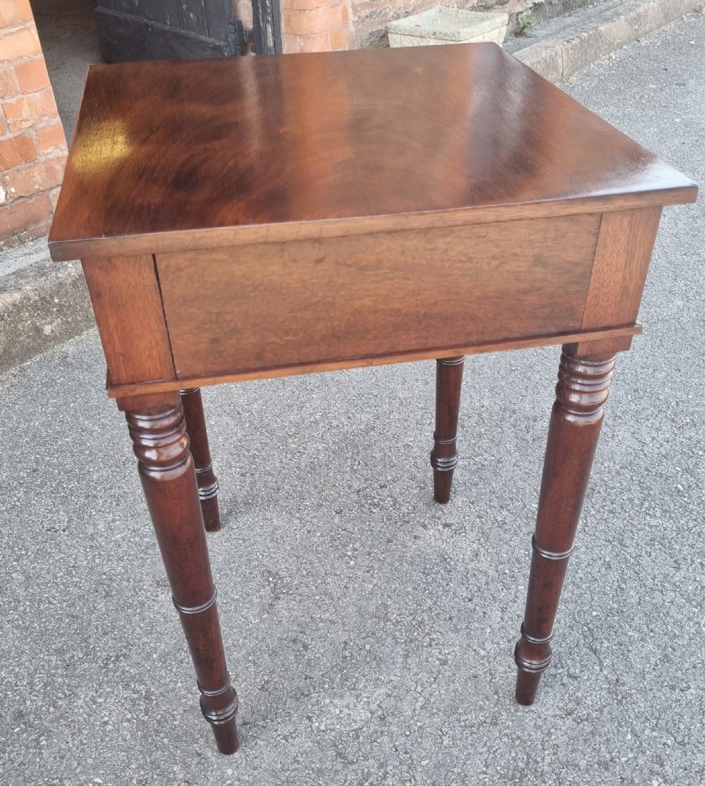 A 19th-century mahogany side table featuring a single drawer with two circular brass ring pulls and four tall turned legs. View V