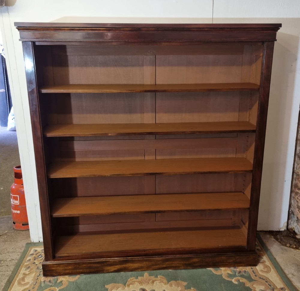 A large Victorian mahogany open bookcase with five adjustable shelves, a moulded upper cornice, and a solid plinth base.