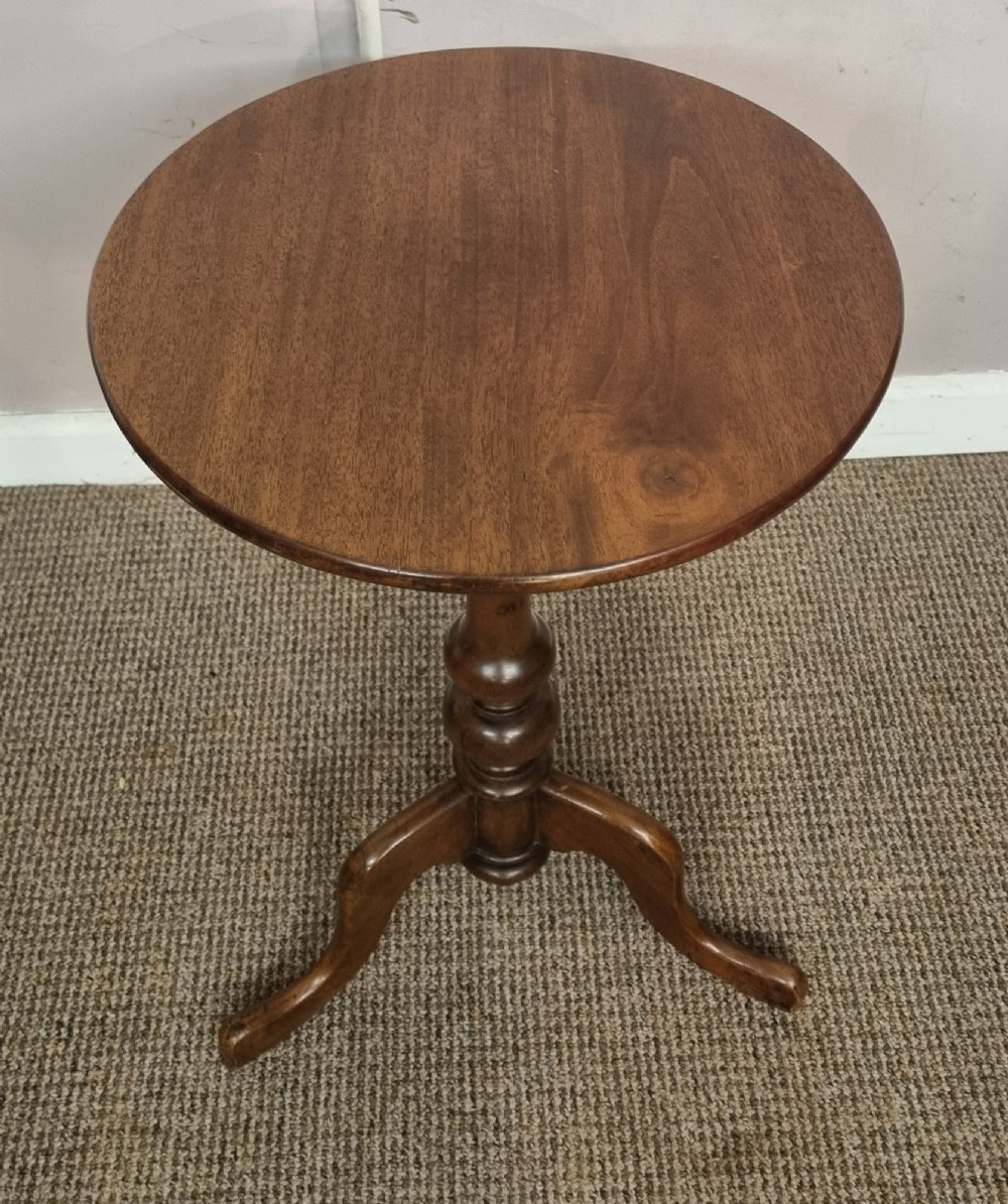 A Victorian mahogany tripod table with a circular top, turned central column, and three splayed legs. View II