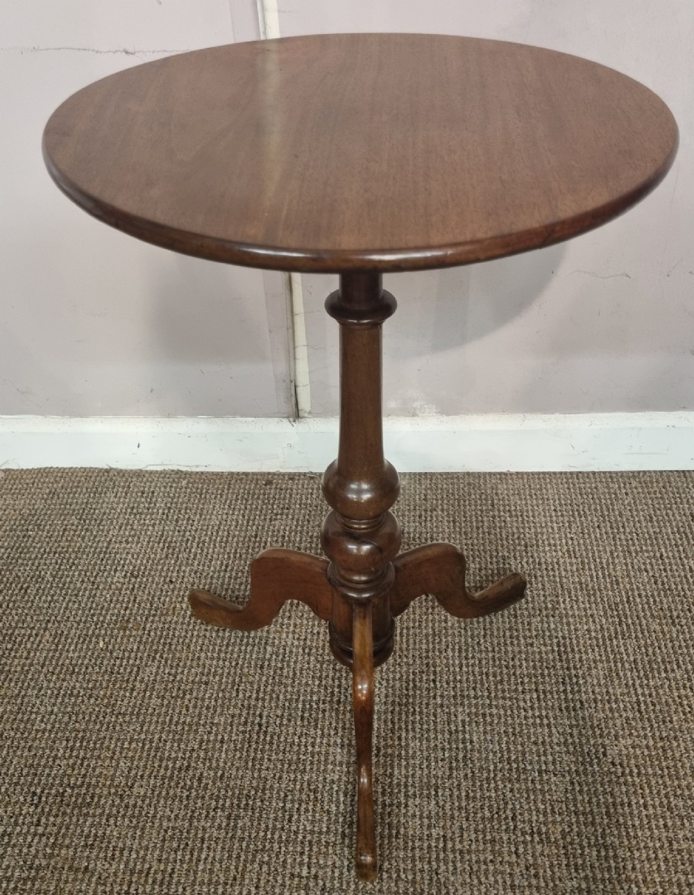 A Victorian mahogany tripod table with a circular top, turned central column, and three splayed legs. View III
