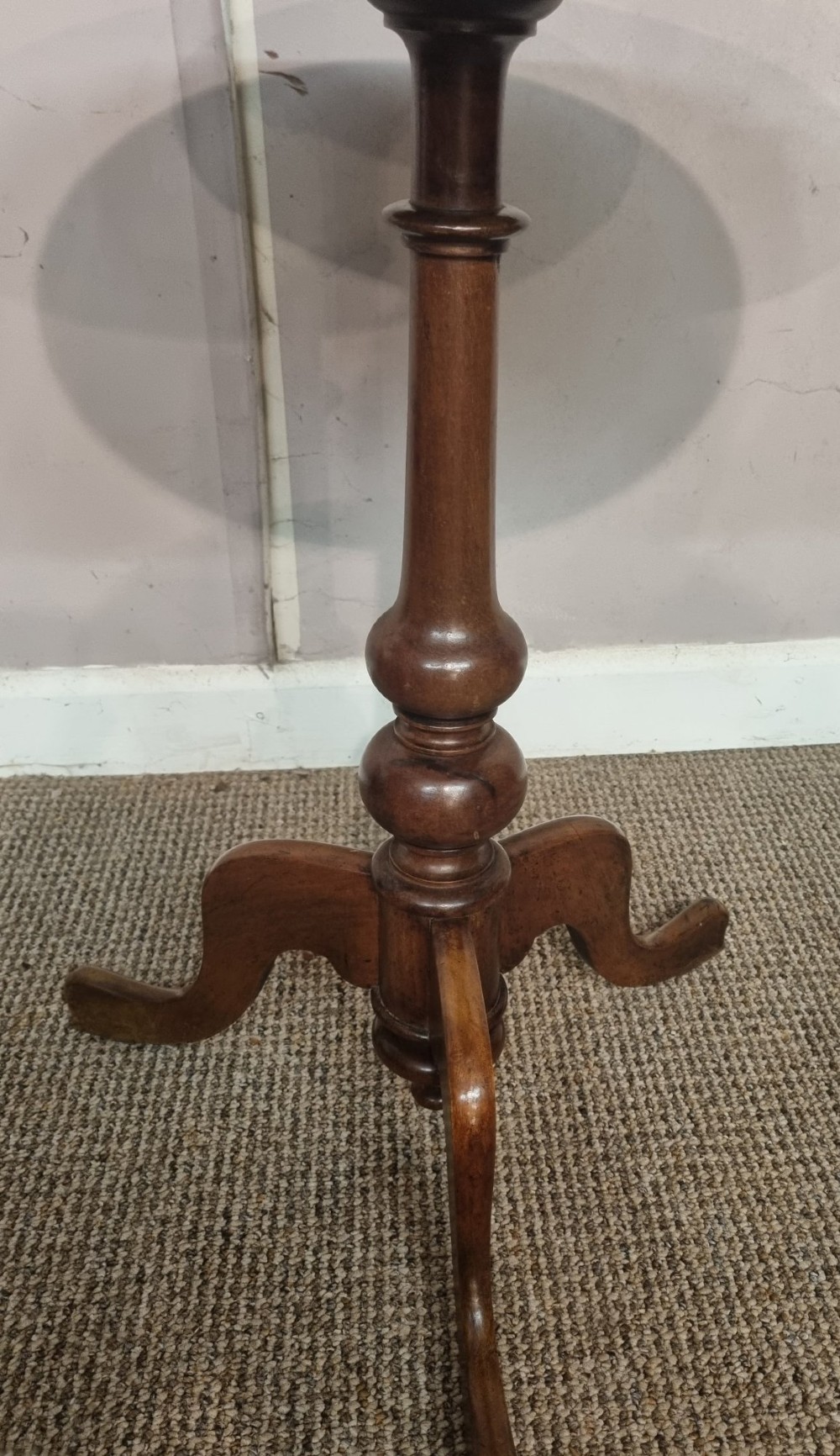 A Victorian mahogany tripod table with a circular top, turned central column, and three splayed legs. View IV
