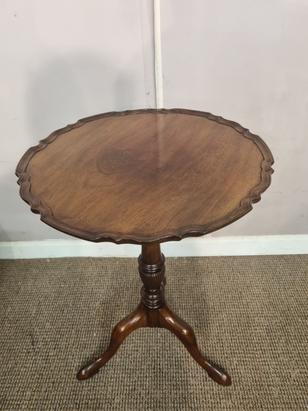 A Georgian mahogany tilt-top table featuring a circular scalloped pie-crust edge, a turned central column, and a tripod base. View II