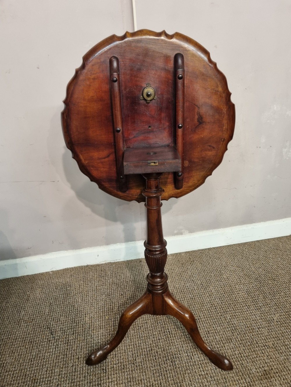 A Georgian mahogany tilt-top table featuring a circular scalloped pie-crust edge, a turned central column, and a tripod base. View V