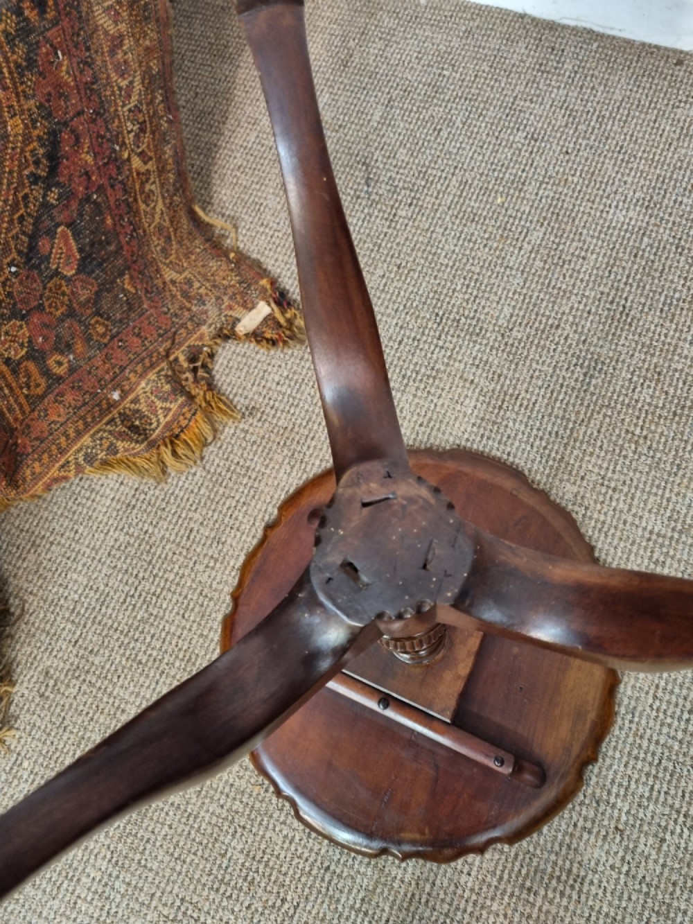 A Georgian mahogany tilt-top table featuring a circular scalloped pie-crust edge, a turned central column, and a tripod base. View VII