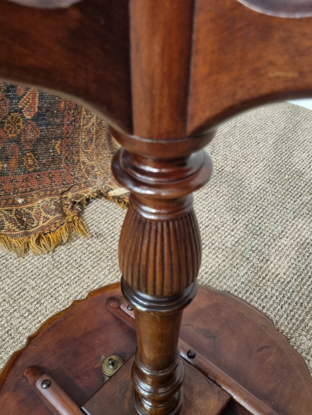 A Georgian mahogany tilt-top table featuring a circular scalloped pie-crust edge, a turned central column, and a tripod base. View VIII