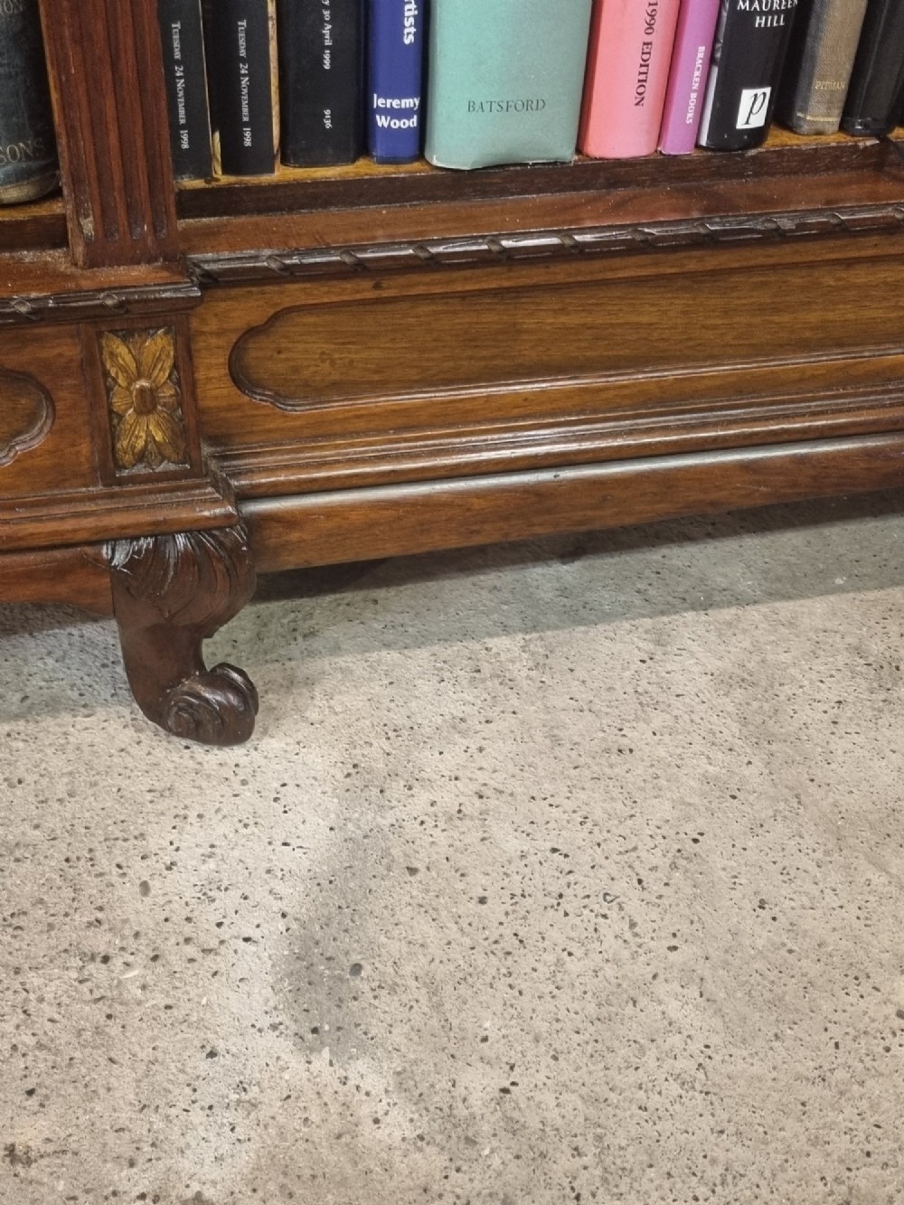 An Edwardian walnut breakfront open bookcase with three fitted sections, carved patera details, and fluted pilasters. View XII
