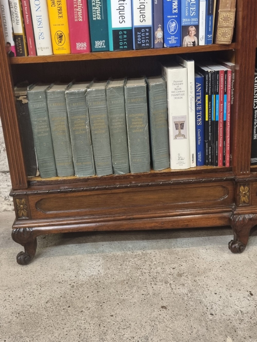 An Edwardian walnut breakfront open bookcase with three fitted sections, carved patera details, and fluted pilasters. View XIII