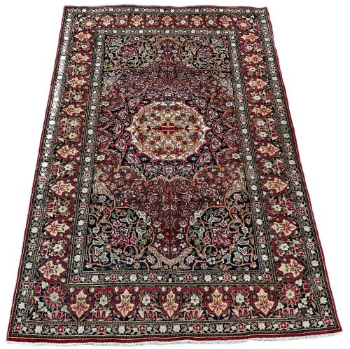 fig 1. A rectangular hand-knotted Persian Isfahan rug featuring an intricate central medallion surrounded by dense floral scrollwork in shades of crimson red, navy blue, and ivory.