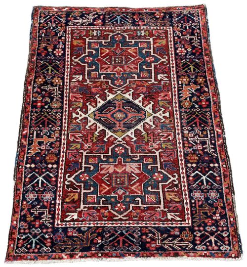 fig 1. An antique hand-knotted Karaja wool rug featuring three distinct geometric medallions in red, navy blue, and ivory tones surrounded by a dense tribal border.