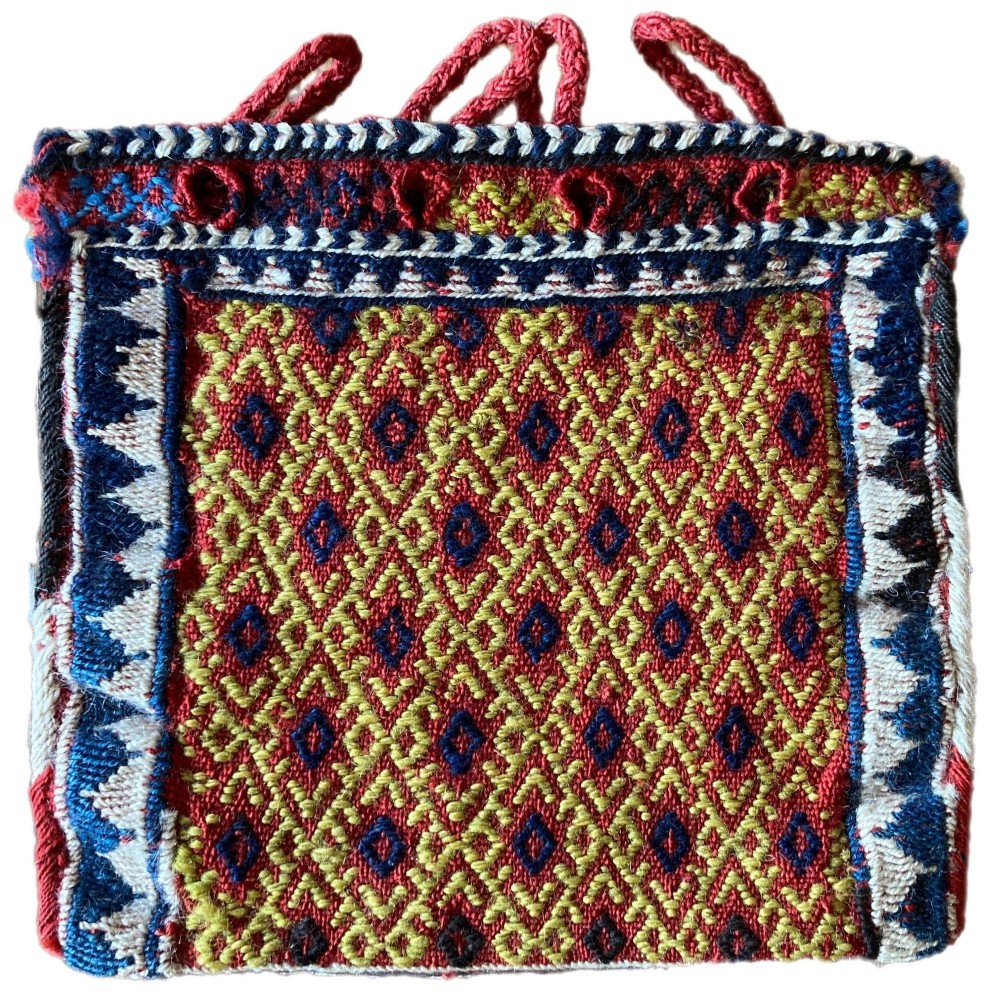 A small square hand-woven Bakhtiari chanteh pouch displaying geometric diamond patterns in red, yellow, blue, and white with woven loop handles.