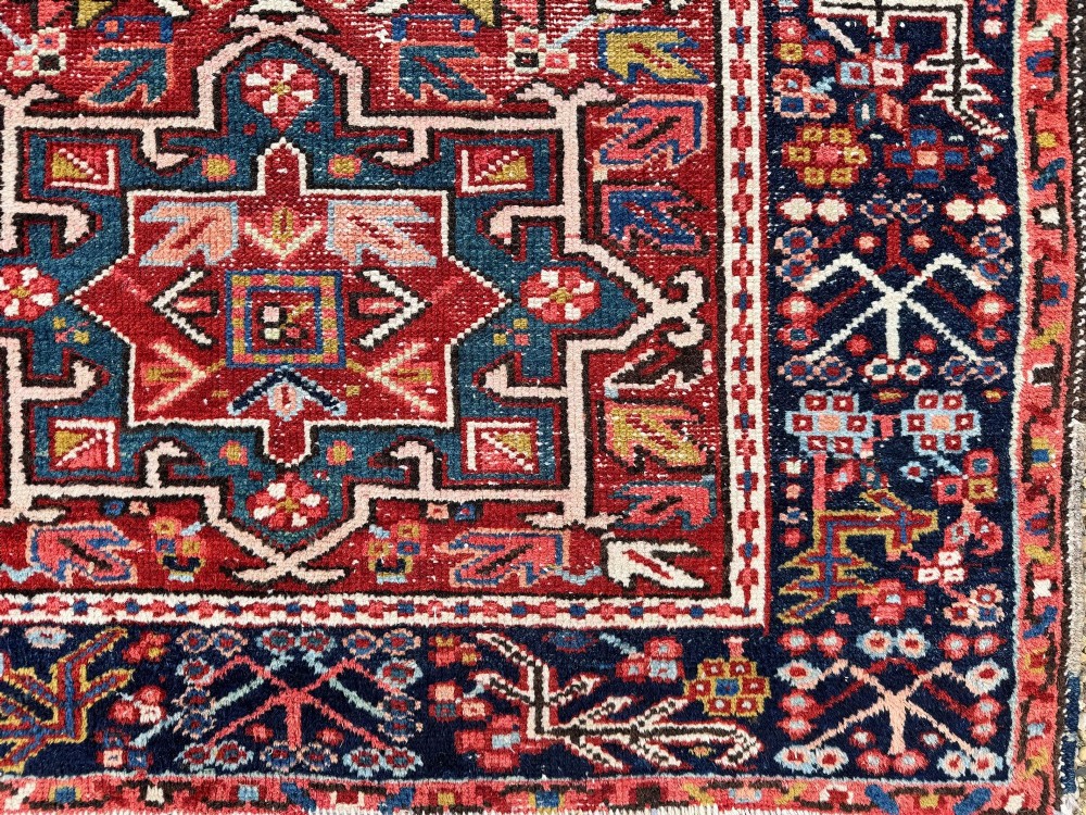 An antique hand-knotted Karaja wool rug featuring three distinct geometric medallions in red, navy blue, and ivory tones surrounded by a dense tribal border. View VII