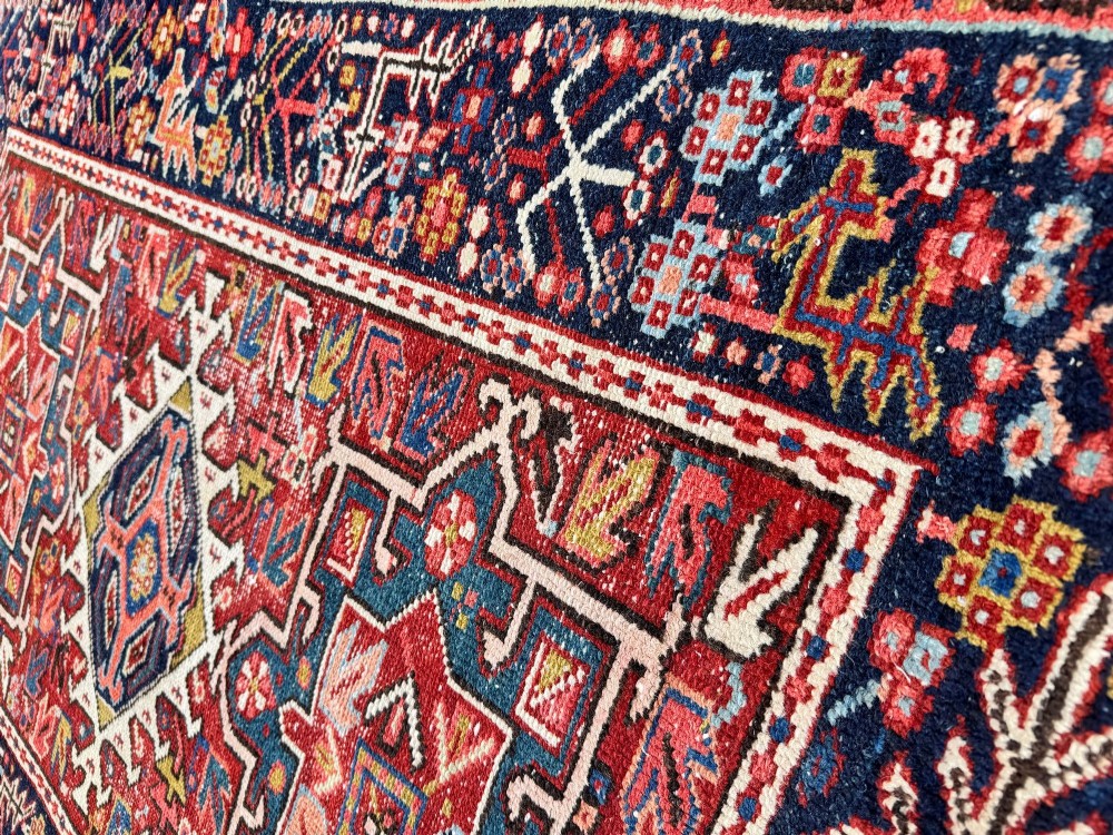 An antique hand-knotted Karaja wool rug featuring three distinct geometric medallions in red, navy blue, and ivory tones surrounded by a dense tribal border. View IX