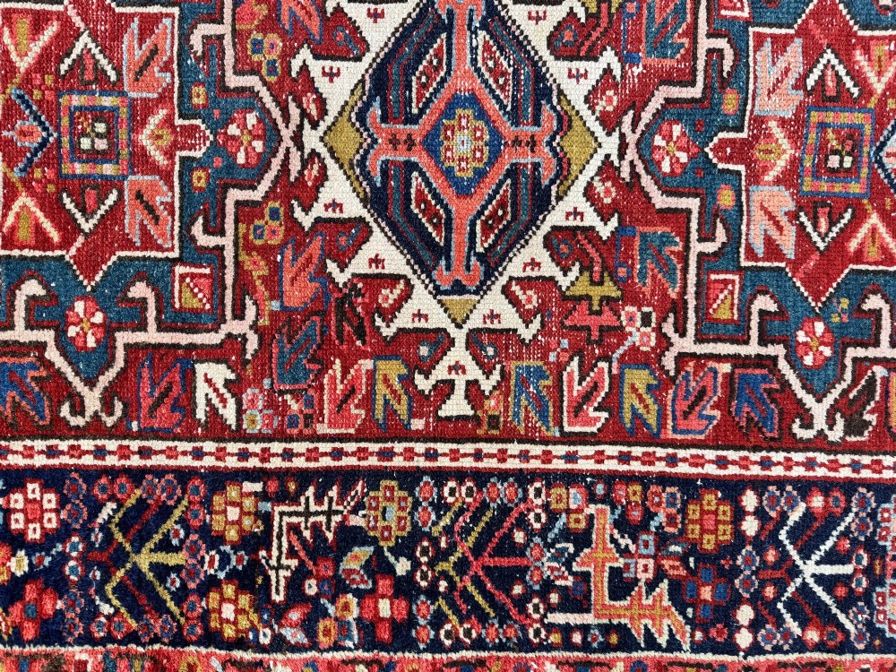 An antique hand-knotted Karaja wool rug featuring three distinct geometric medallions in red, navy blue, and ivory tones surrounded by a dense tribal border. View XIII