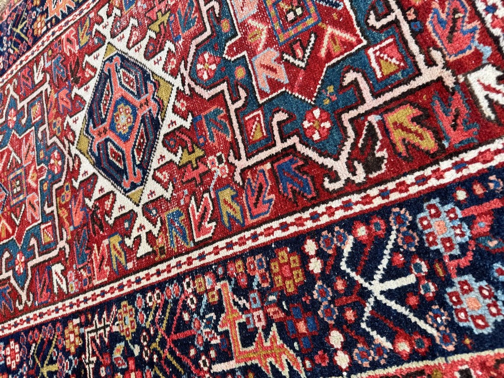 An antique hand-knotted Karaja wool rug featuring three distinct geometric medallions in red, navy blue, and ivory tones surrounded by a dense tribal border. View XV