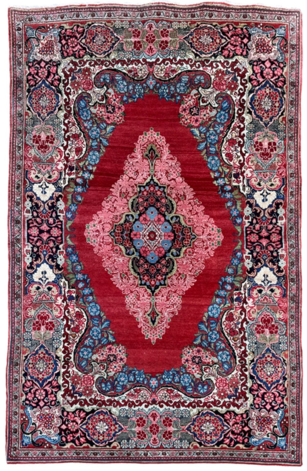 Hand-knotted antique Persian Sarouk wool rug featuring a large central floral medallion on a rich red ground with elaborate decorative borders.