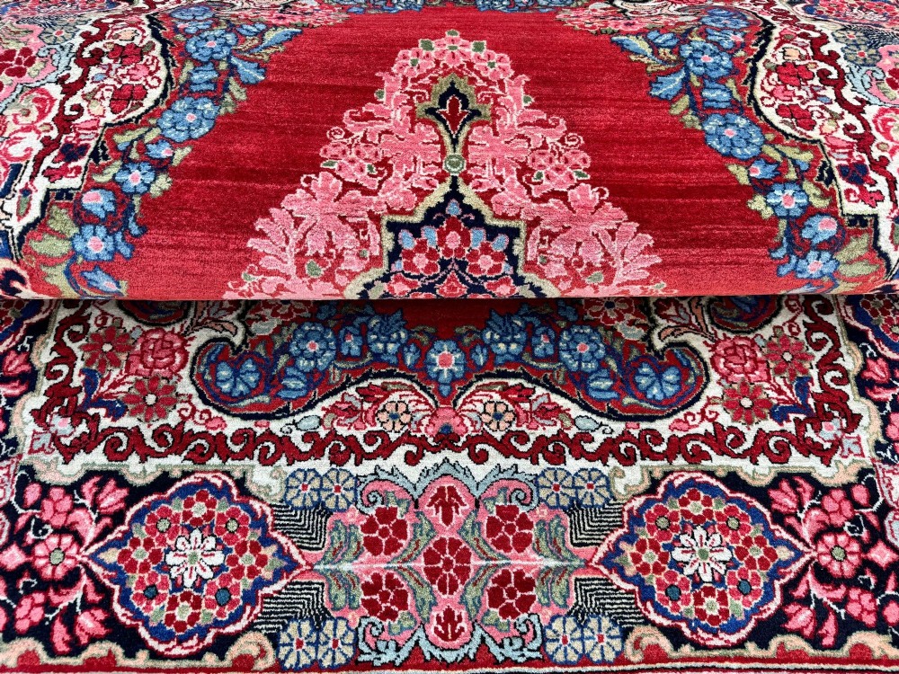 Hand-knotted antique Persian Sarouk wool rug featuring a large central floral medallion on a rich red ground with elaborate decorative borders. View XV
