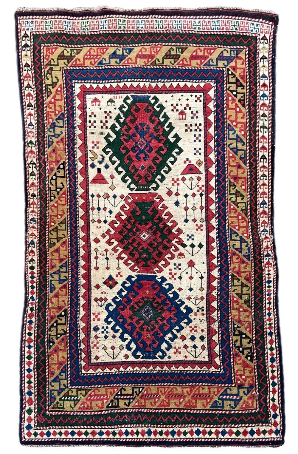 An antique hand-knotted Caucasian Kazak wool rug featuring three stacked geometric medallions on an ivory ground with multi-coloured geometric borders.