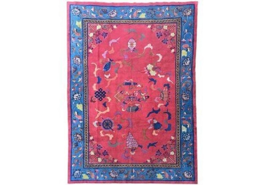 A hand-knotted Chinese Art Deco wool rug featuring a bright pink central field with traditional floral motifs surrounded by a blue patterned border.