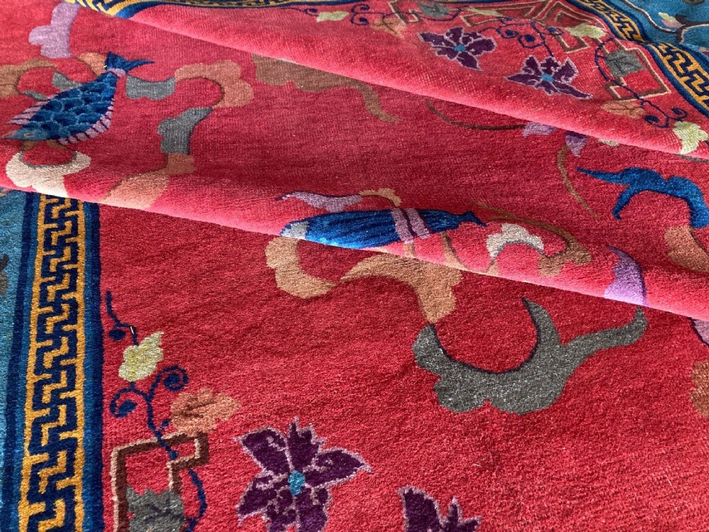 A hand-knotted Chinese Art Deco wool rug featuring a bright pink central field with traditional floral motifs surrounded by a blue patterned border. View XII
