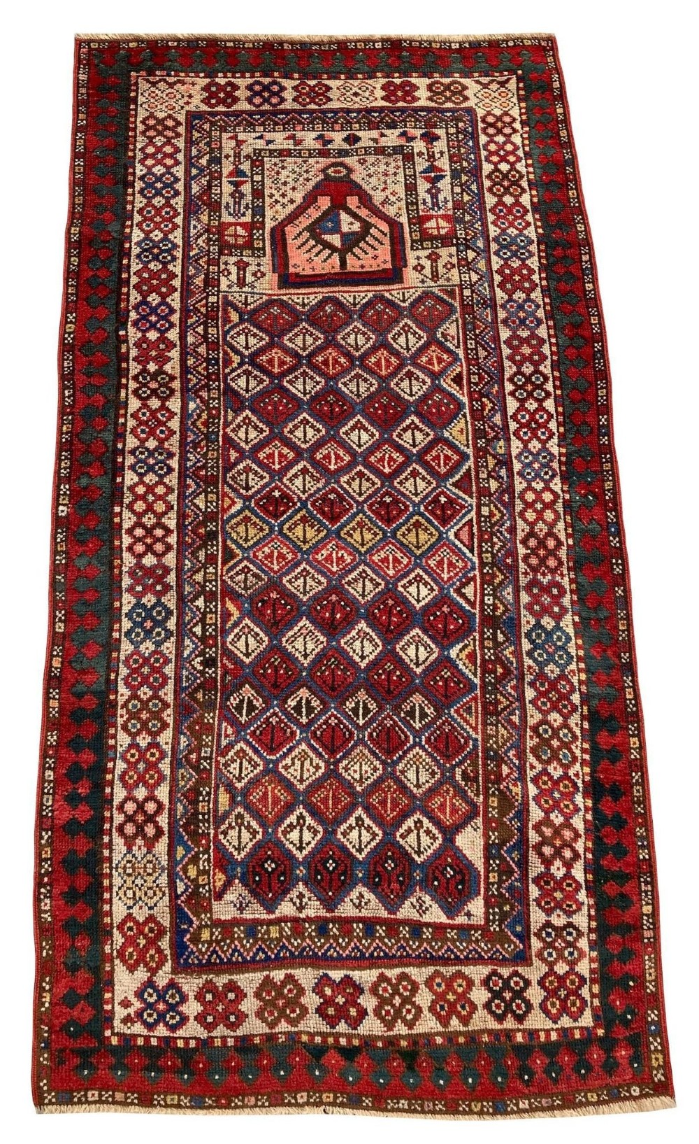 A hand-knotted antique Caucasian Gendje prayer rug featuring a deep red central field with a diamond lattice pattern, topped with a geometric mihrab motif and framed by multi-coloured decorative borders. View II