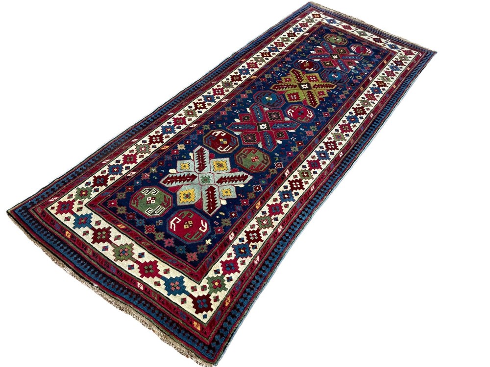 An elongated Caucasian Talish runner rug featuring geometric star motifs and octagons set against a deep indigo field with patterned borders. View III