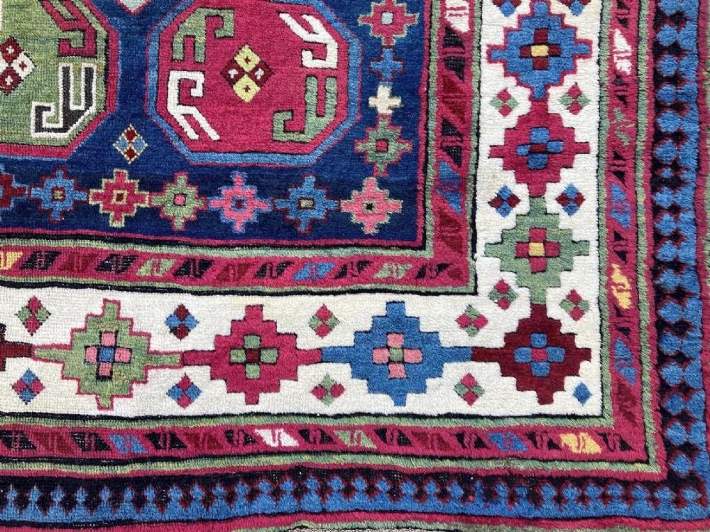 An elongated Caucasian Talish runner rug featuring geometric star motifs and octagons set against a deep indigo field with patterned borders. View VI