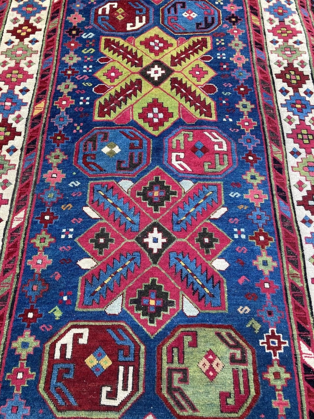 An elongated Caucasian Talish runner rug featuring geometric star motifs and octagons set against a deep indigo field with patterned borders. View VII
