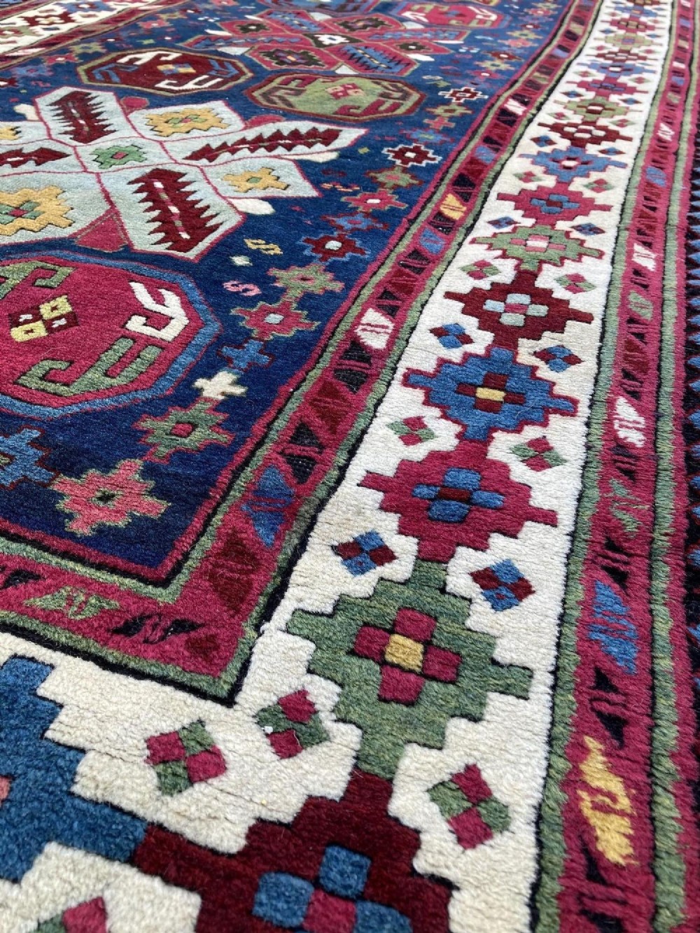 An elongated Caucasian Talish runner rug featuring geometric star motifs and octagons set against a deep indigo field with patterned borders. View VIII