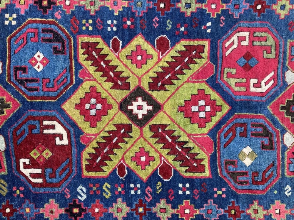 An elongated Caucasian Talish runner rug featuring geometric star motifs and octagons set against a deep indigo field with patterned borders. View XI