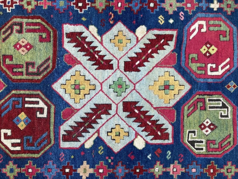 An elongated Caucasian Talish runner rug featuring geometric star motifs and octagons set against a deep indigo field with patterned borders. View XII
