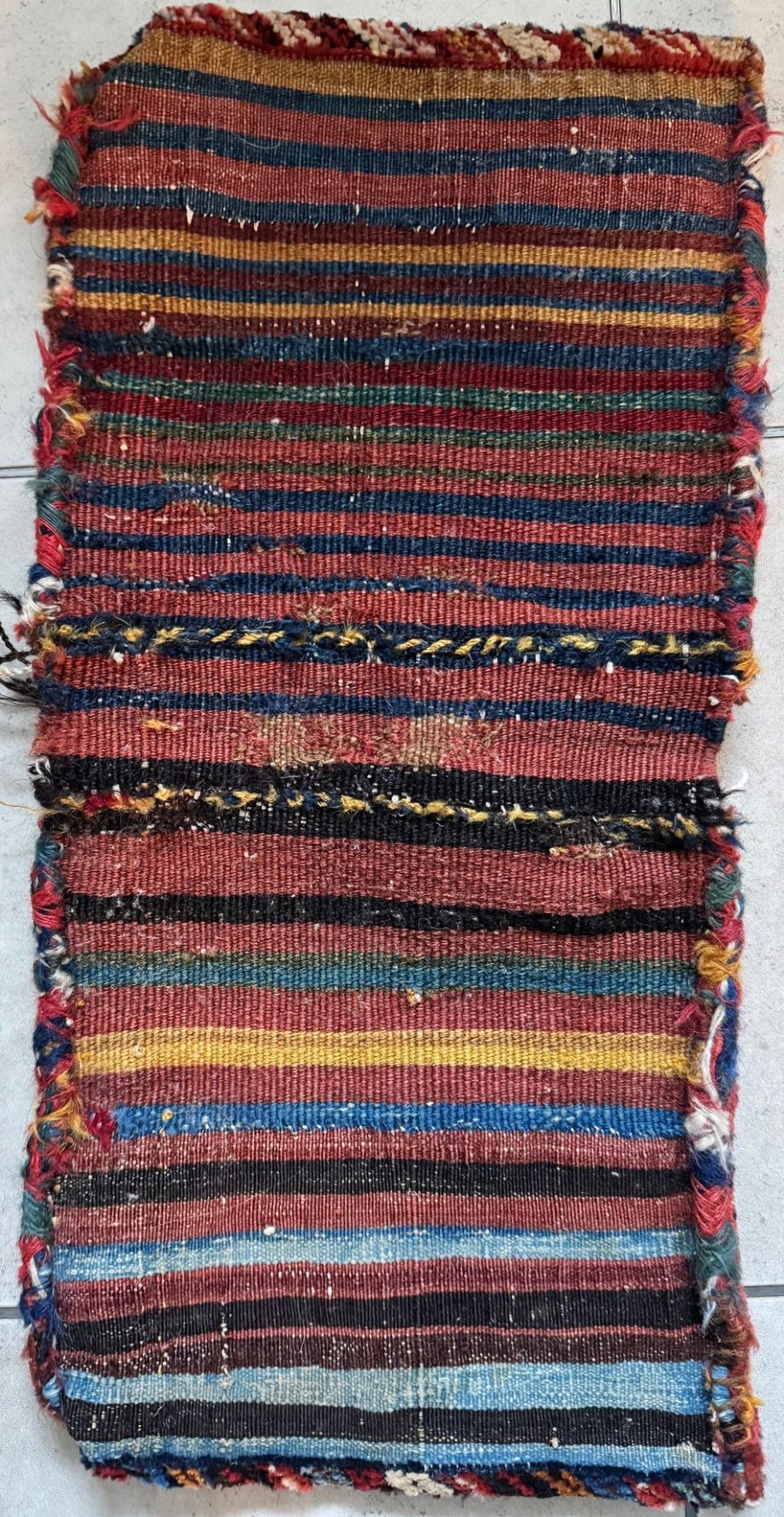 An antique handwoven Qashqai wool Khorjin double saddlebag featuring geometric medallions in red, navy, and cream with braided closure loops. View XIV
