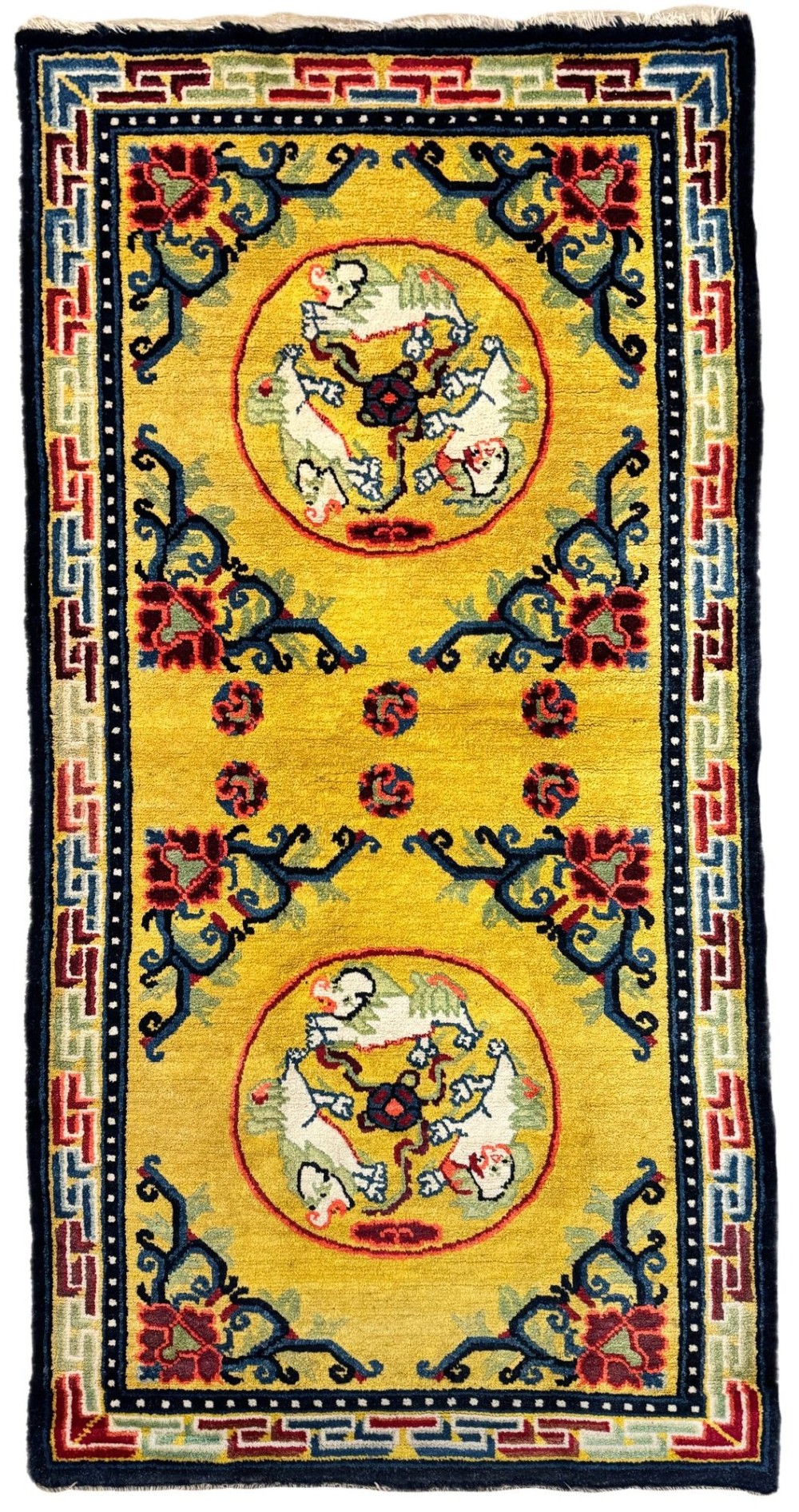 An antique hand-knotted Chinese Ningxia rectangular wool rug featuring a bright yellow field with two circular animal medallions, floral corner accents, and a blue geometric fretwork border.