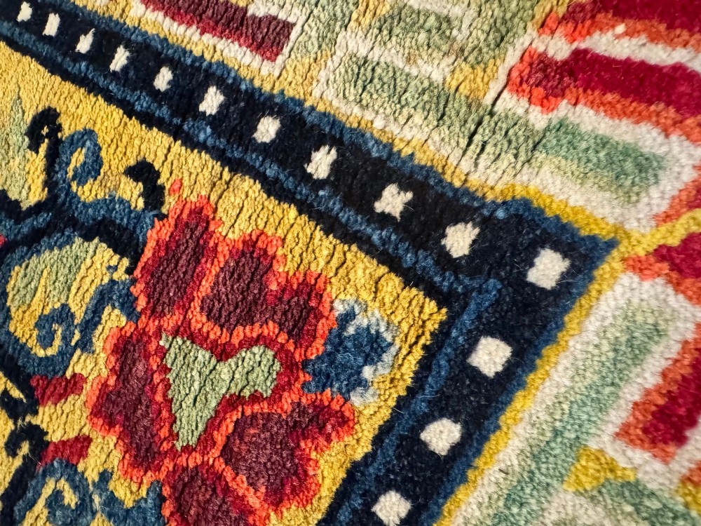 An antique hand-knotted Chinese Ningxia rectangular wool rug featuring a bright yellow field with two circular animal medallions, floral corner accents, and a blue geometric fretwork border. View X