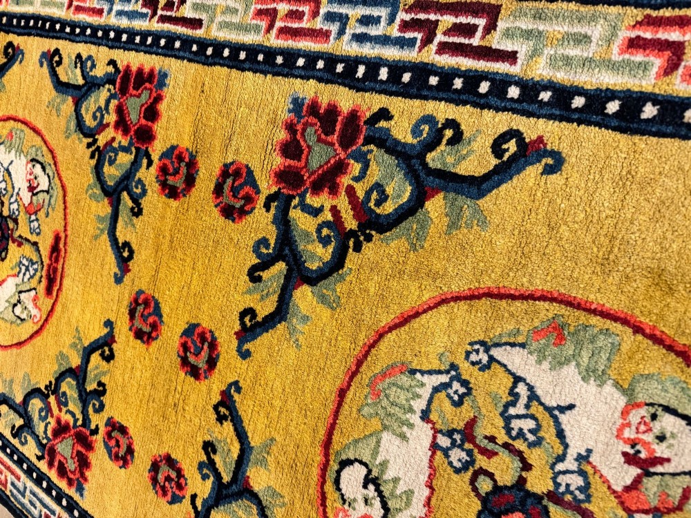 An antique hand-knotted Chinese Ningxia rectangular wool rug featuring a bright yellow field with two circular animal medallions, floral corner accents, and a blue geometric fretwork border. View XV