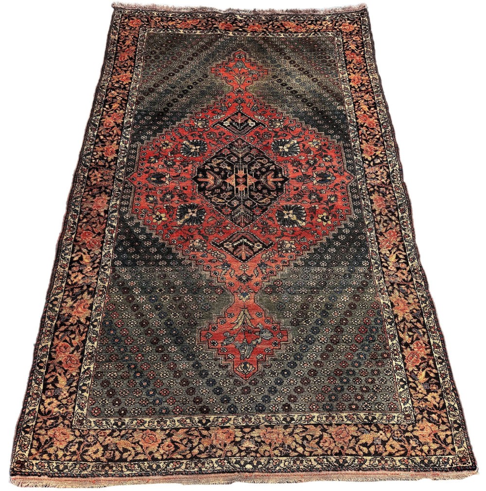 An antique hand-knotted Bakhtiar wool rug featuring a central terracotta stepped medallion on a dark indigo field filled with intricate floral motifs. View II