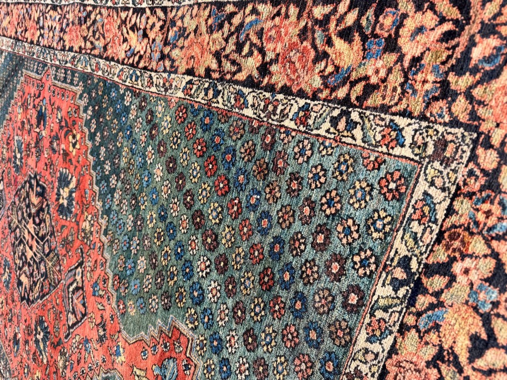 An antique hand-knotted Bakhtiar wool rug featuring a central terracotta stepped medallion on a dark indigo field filled with intricate floral motifs. View IX