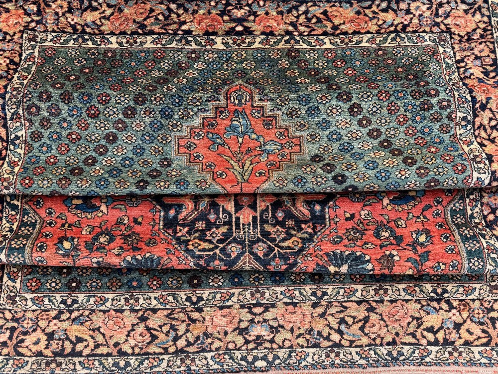 An antique hand-knotted Bakhtiar wool rug featuring a central terracotta stepped medallion on a dark indigo field filled with intricate floral motifs. View XV