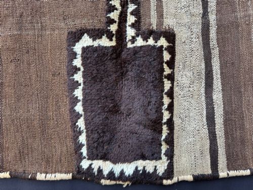 fig 2. A square antique handwoven Persian Tacheh featuring vertical brown and beige stripes with a dark central raised pile motif.