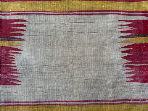 fig 1. A square antique flatwoven Persian Sofreh textile featuring red, yellow, and grey horizontal stripes bordering an unpatterned central cream field with serrated side accents.