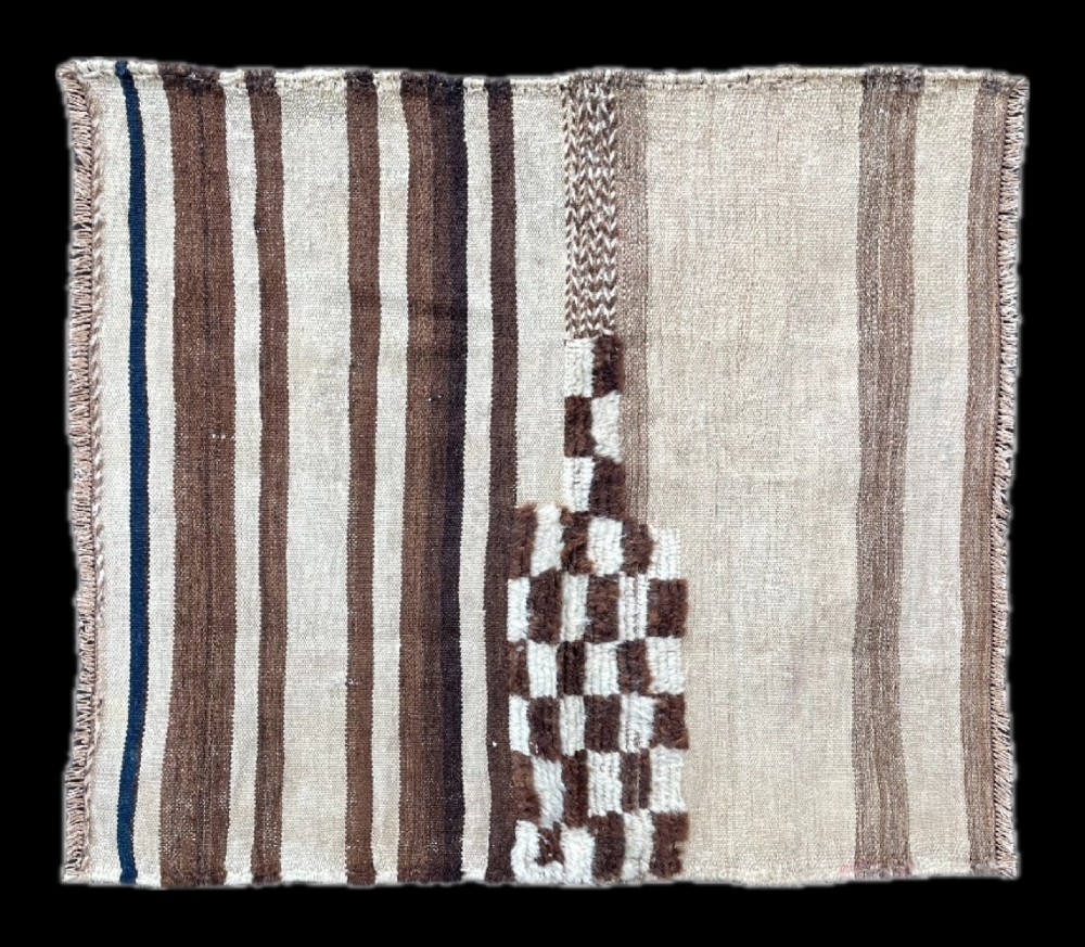 A square antique woven Persian Tacheh textile with brown and cream vertical stripes alongside a distinctive chequered pile section.