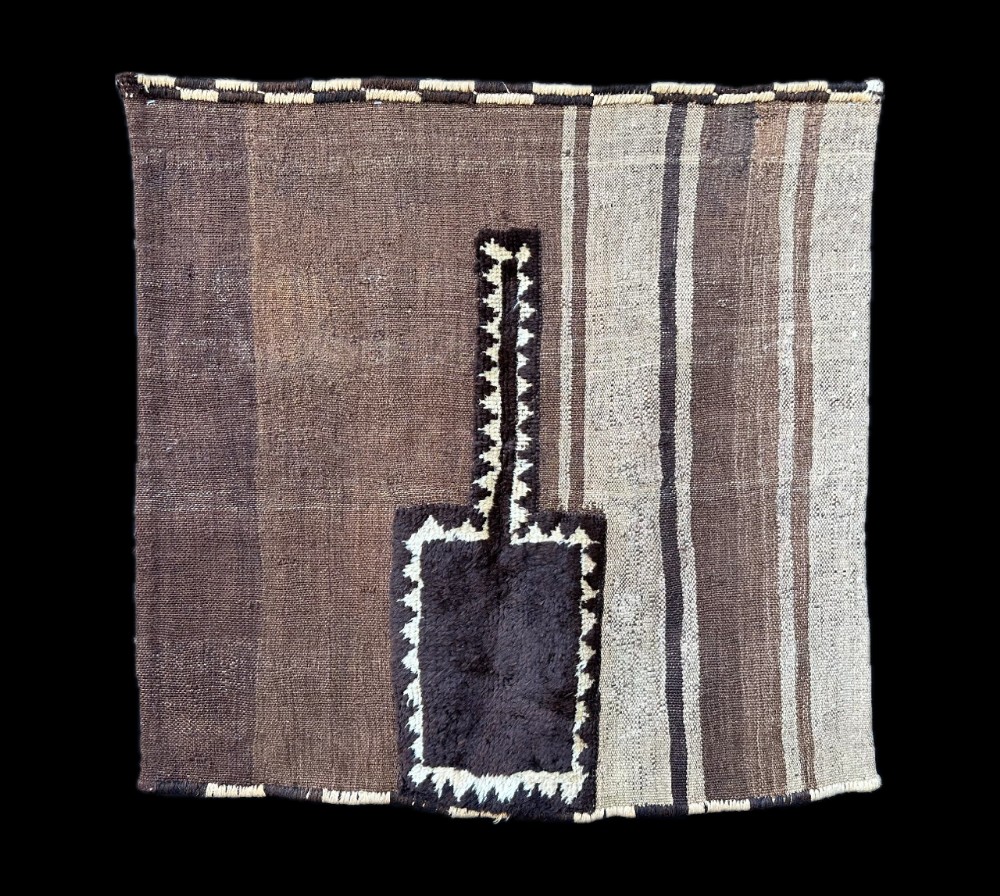A square antique handwoven Persian Tacheh featuring vertical brown and beige stripes with a dark central raised pile motif.