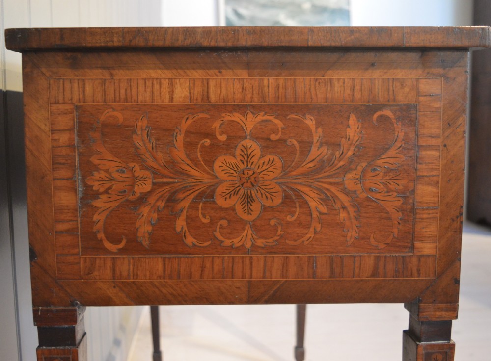 An Italian Neoclassical writing desk crafted from walnut with foliate marquetry inlay across the drawers, tabletop, and tapered legs. View III